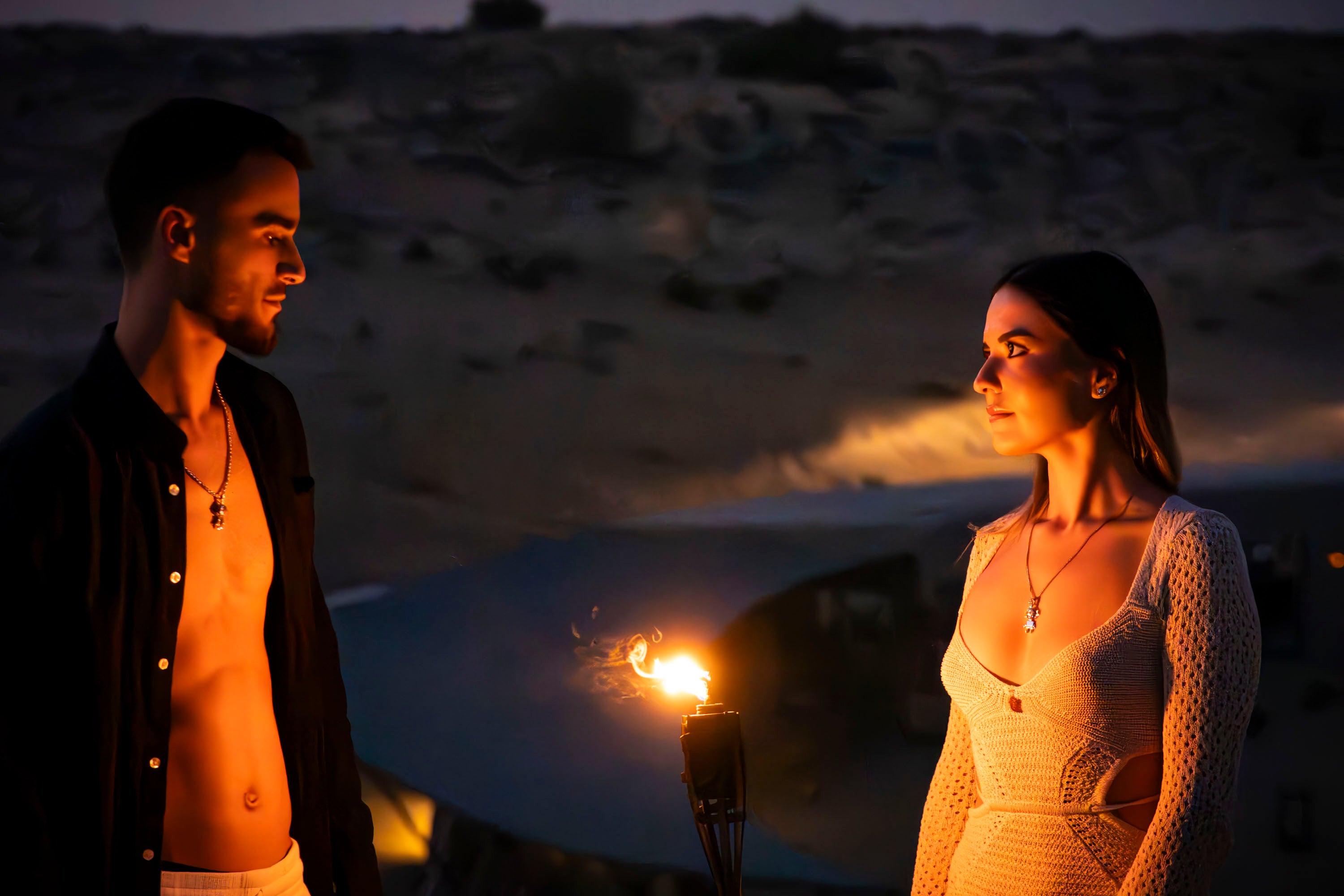 two models are wearing tahos and talia jewel in the desert near fire