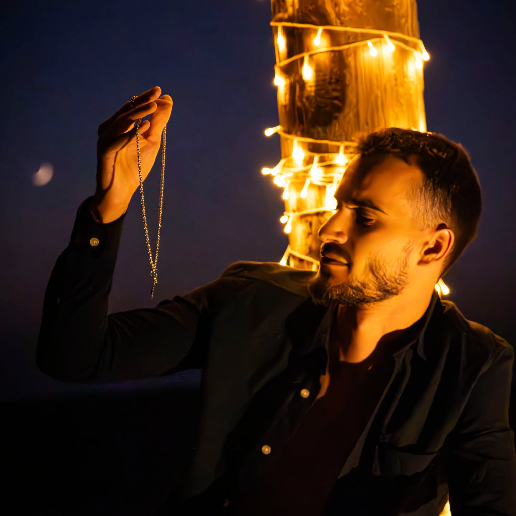 man is holding in this hand tahos jewel necklace